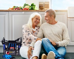 Couple Sitting on Floor of Home with Tools